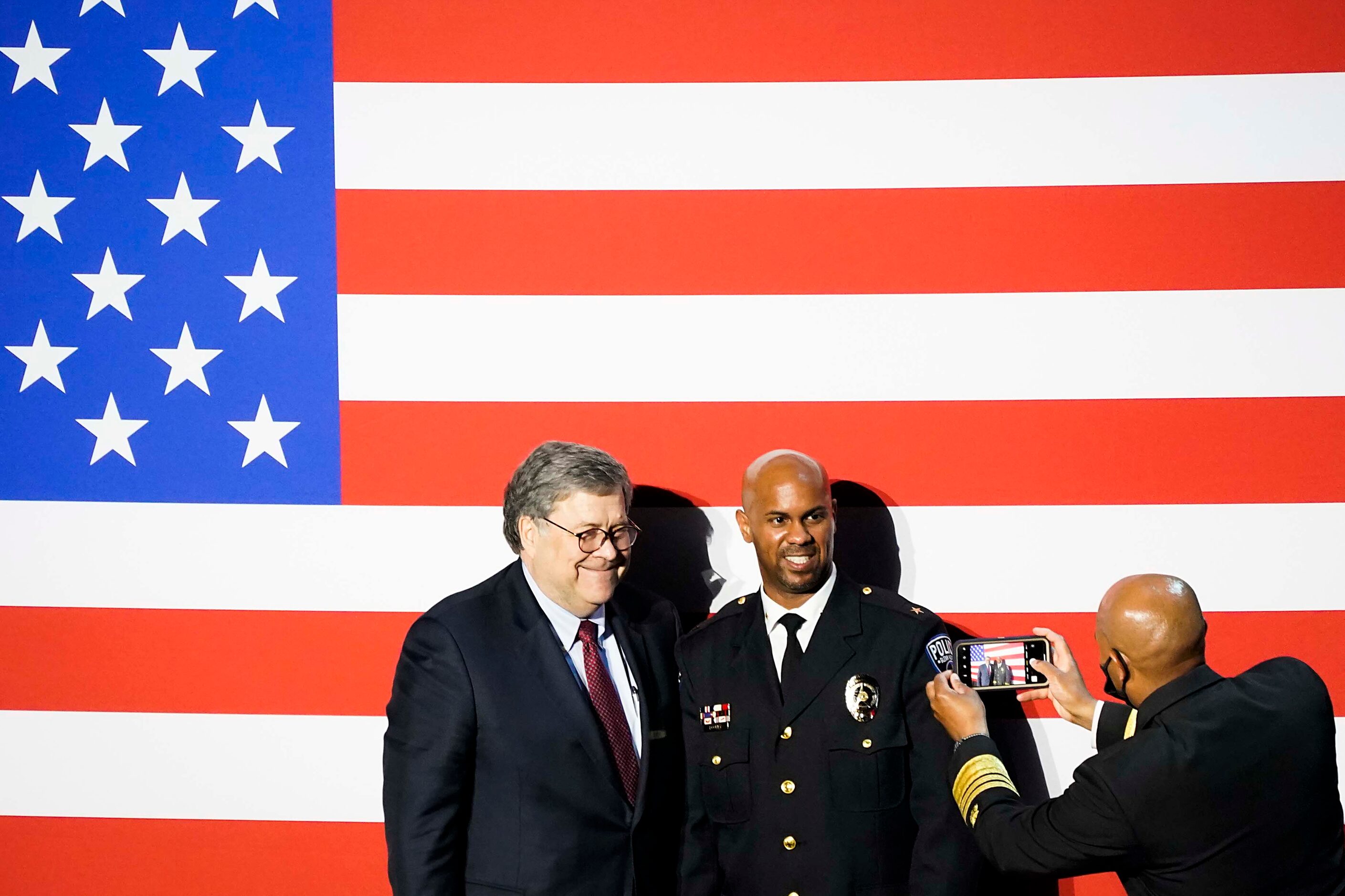 Attorney General William Barr (left) has his photo taken with Glenn Heights Police Chief...