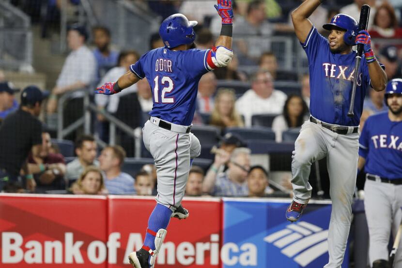 Texas Rangers Rougned Odor (12) celebrates with Rangers on-deck batter Elvis Andrus after...
