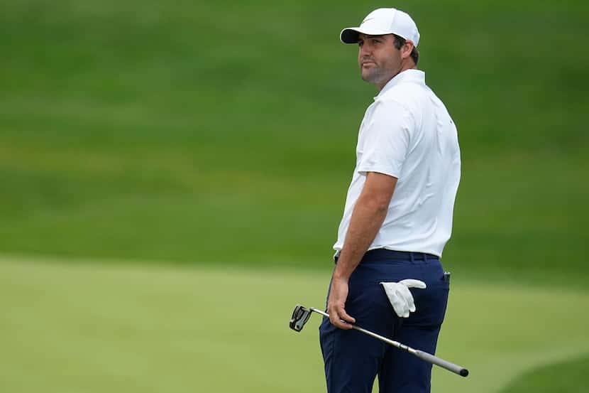 Scottie Scheffler reacts after missing his putt on the fourth green during the second round...