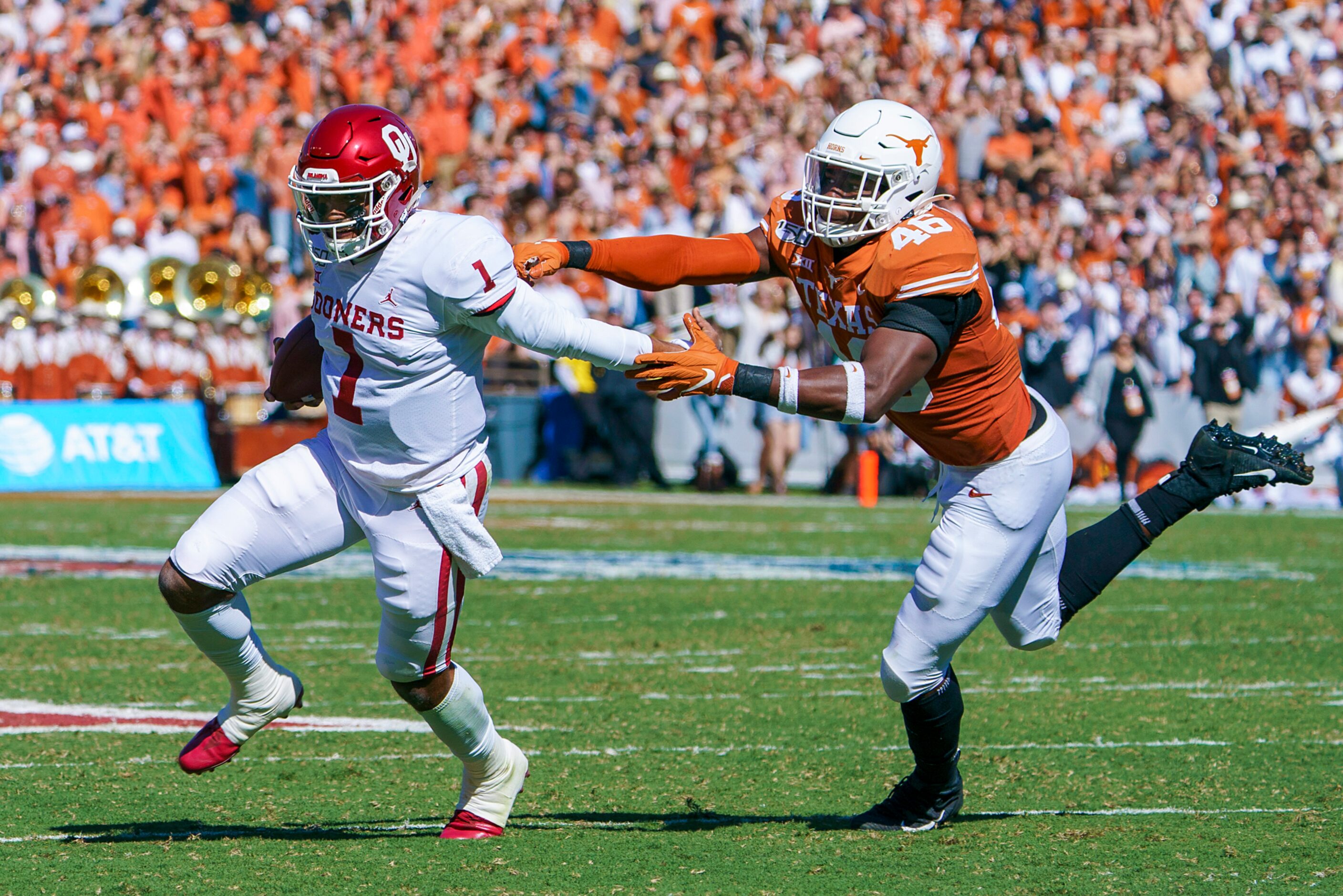 Oklahoma quarterback Jalen Hurts (1) gets away from Texas linebacker Ayodele Adeoye (40)...