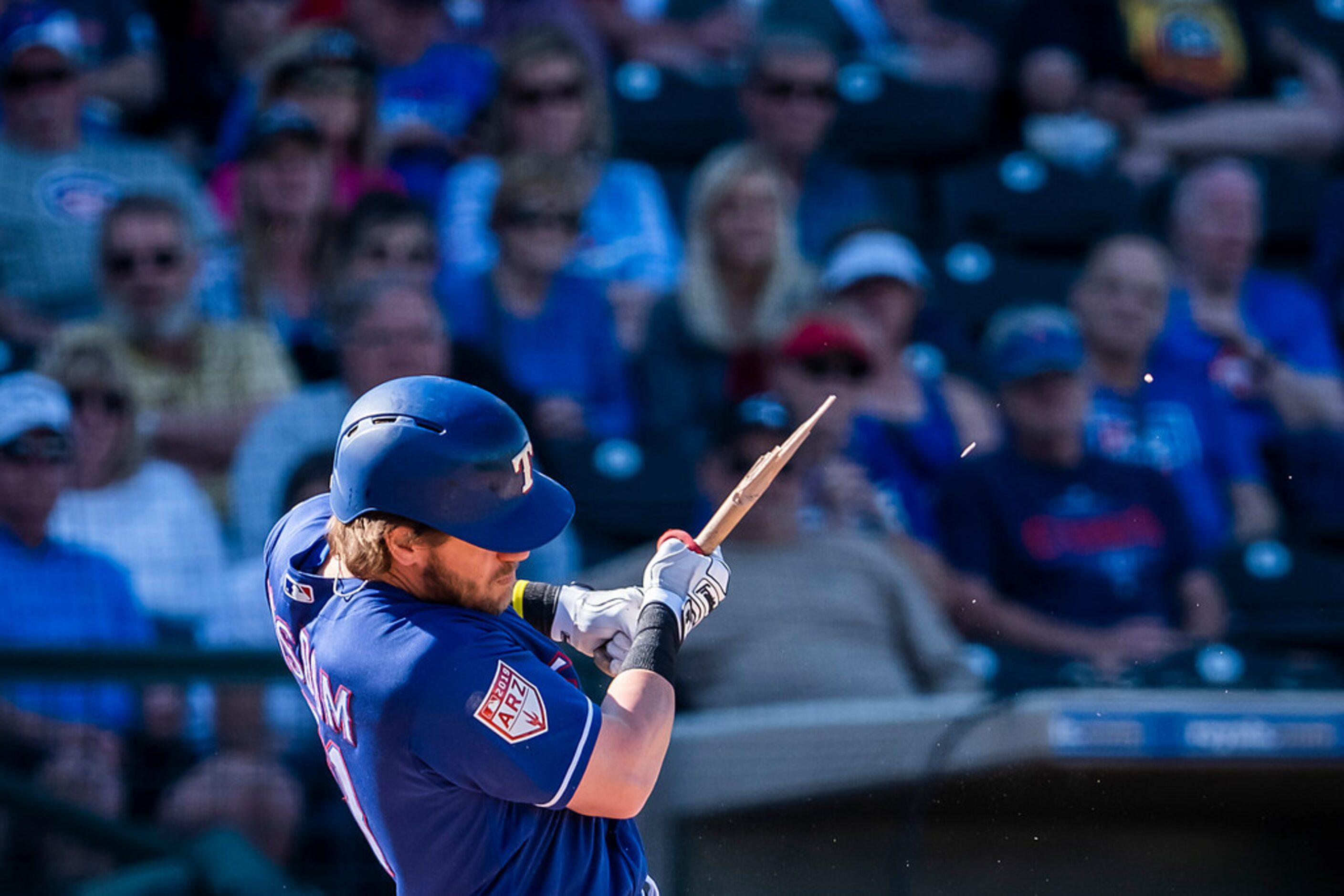 Texas Rangers infielder Patrick Wisdom breaks his bat while popping out to end the seventh...