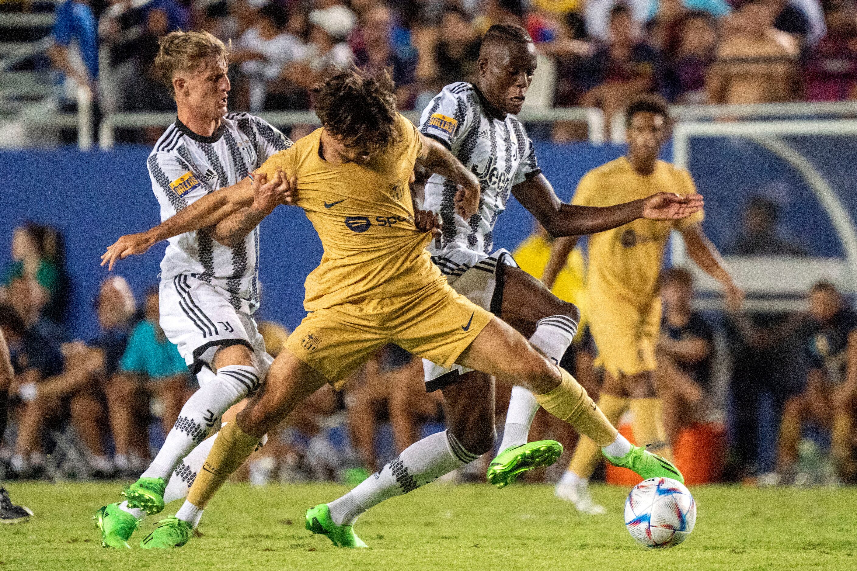 Barcelona midfielder Alex Collado fights through the defense of Juventus midfielders Nicolo...