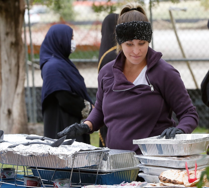 Volunteer Jessie Webb of Dallas prepares to serve food as members of the Dallas Symphony...