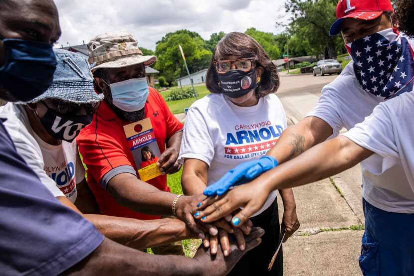 City Council member Carolyn King Arnold (center) and her supporting team huddled before they...