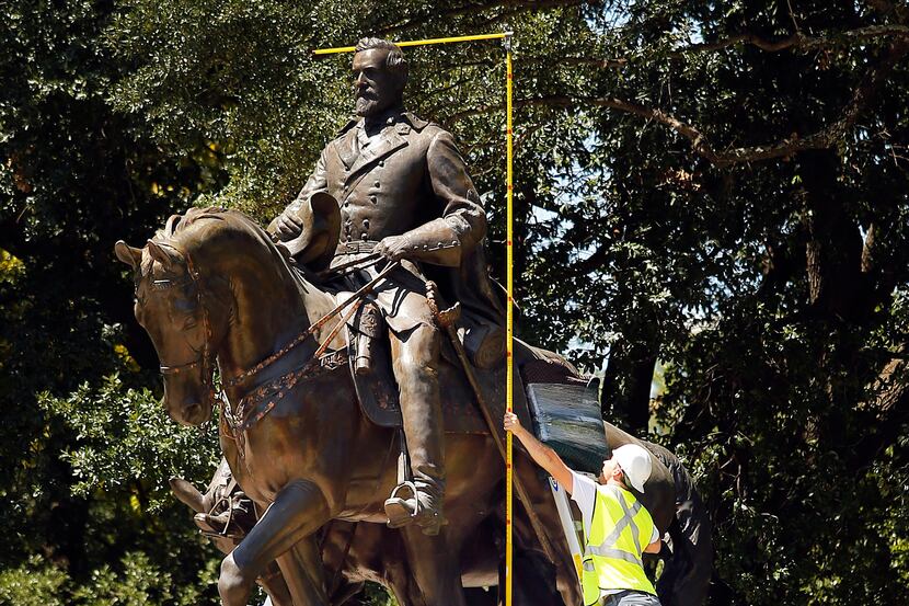 Crewmen from Howell Crane and Rigging Inc. measured the height of the Robert E. Lee statue...