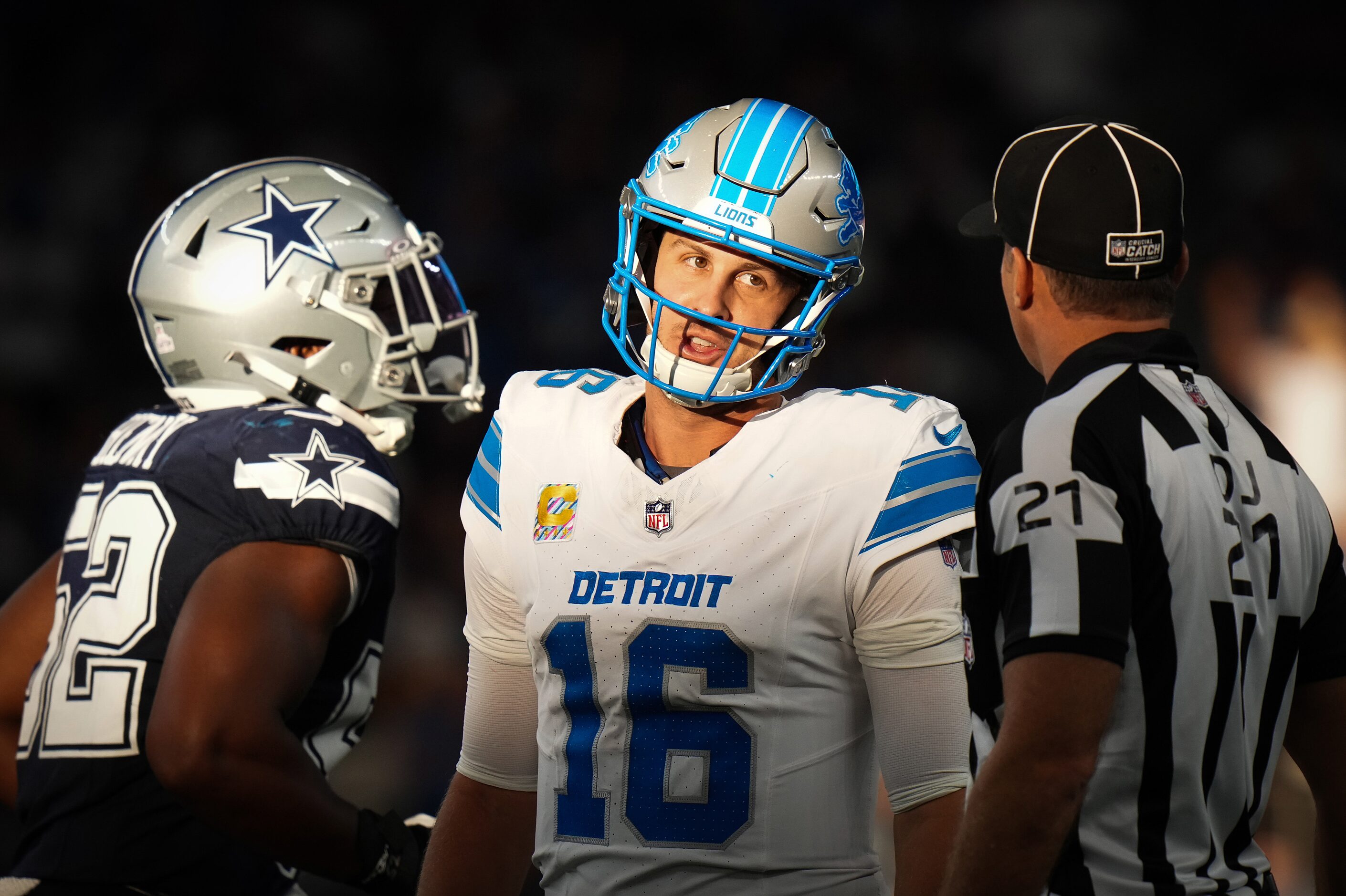 Detroit Lions quarterback Jared Goff (16) questions back judge Grantis Bell (27) after a...