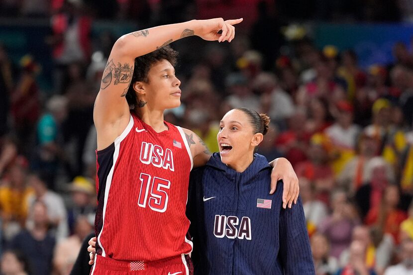 United States' Brittney Griner, left, and United States' Diana Taurasi walk off the court...