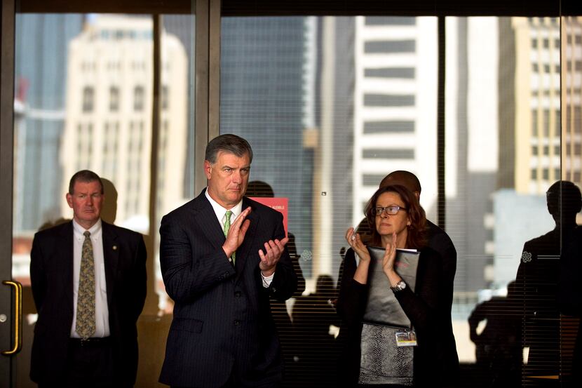 Dallas mayor Mike Rawlings, center, applauds the Men Against Abuse rally before announcing...