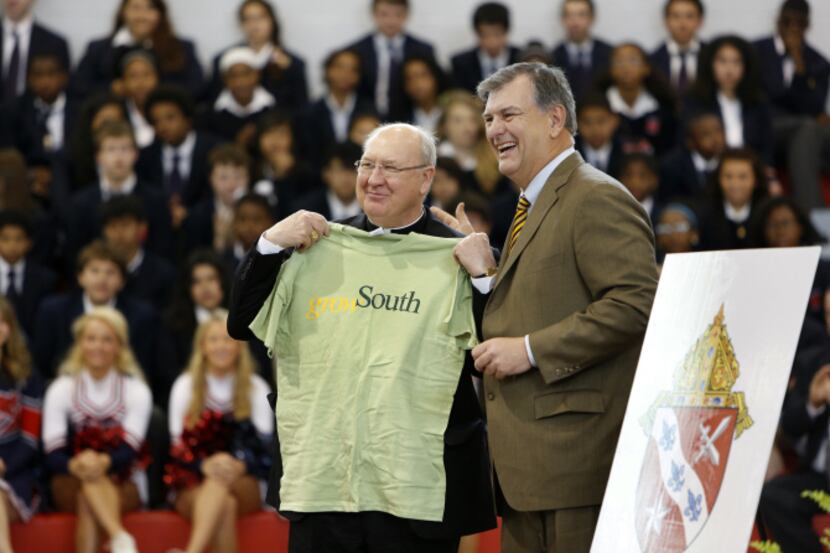 Mayor Mike Rawlings presents a Grow South T-shirt to Bishop Kevin Farrell of the Catholic...