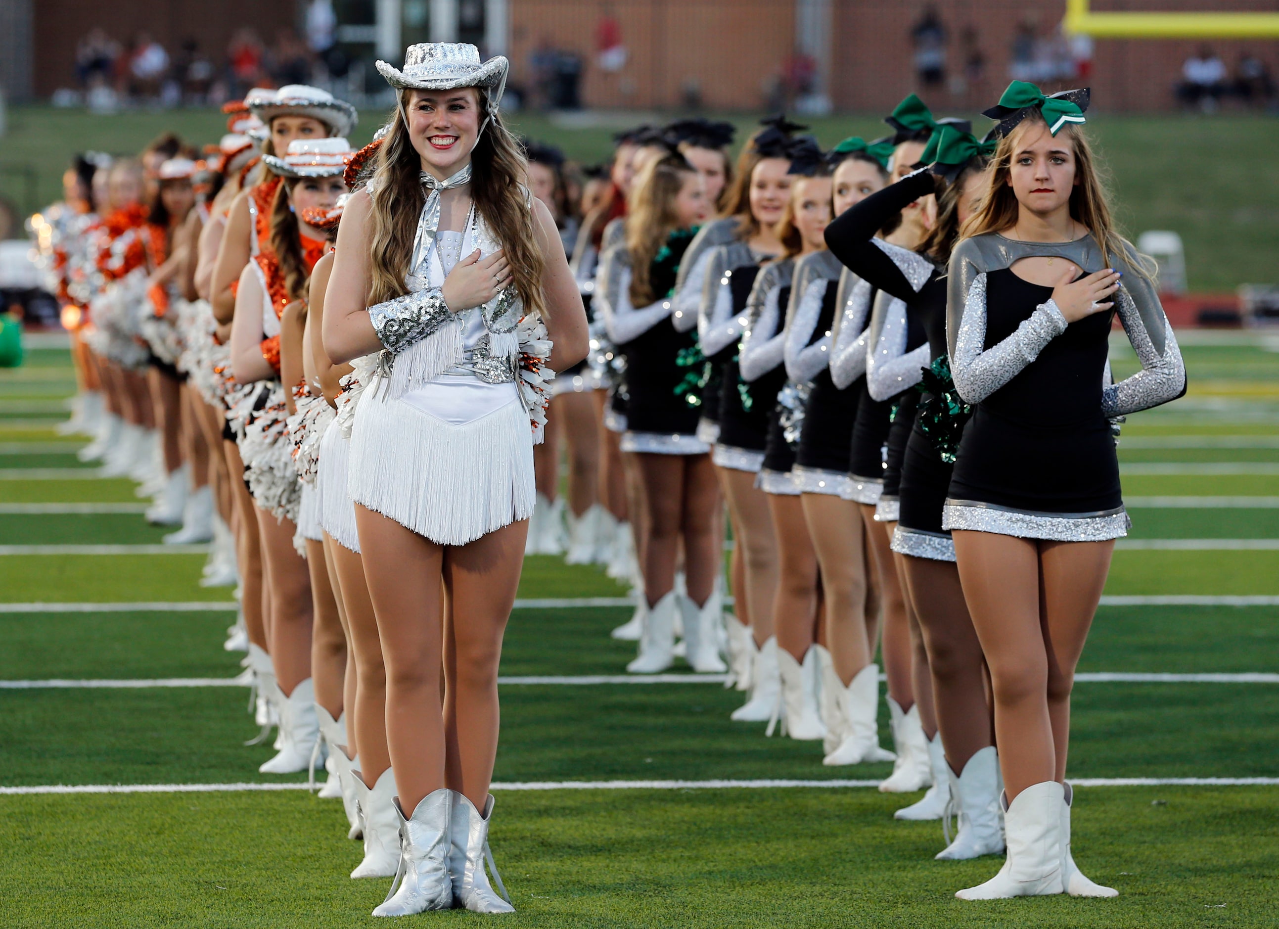 The Rockwall high drill team stands at midfield for the national anthem before the first...