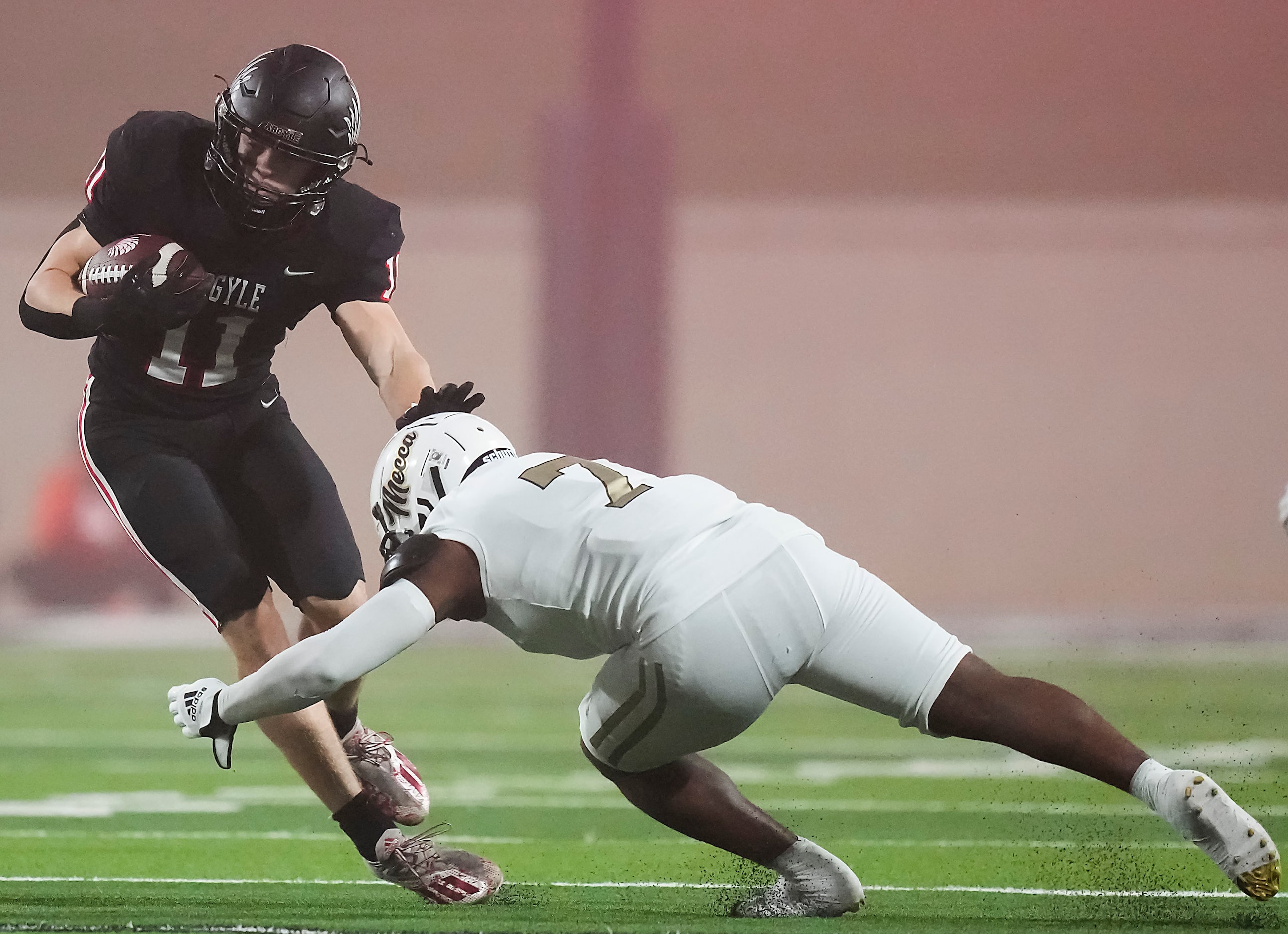 Argyle running back RJ Bunnell (11) is brought down by South Oak Cliff defensive back Abdul...