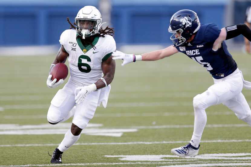 Baylor running back JaMycal Hasty (6) breaks past the tackle attempt by Rice cornerback...
