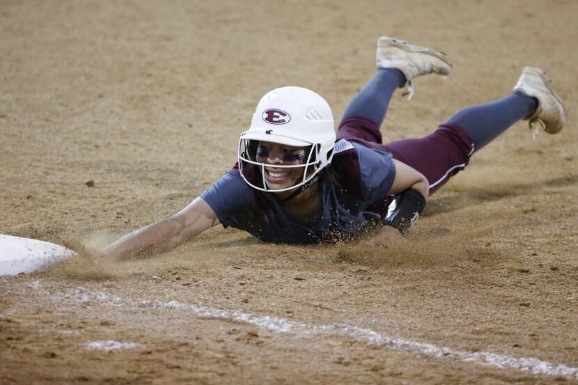 Ennis' Michaela Cochran (1) safely slides back to first base on a play in a game against...