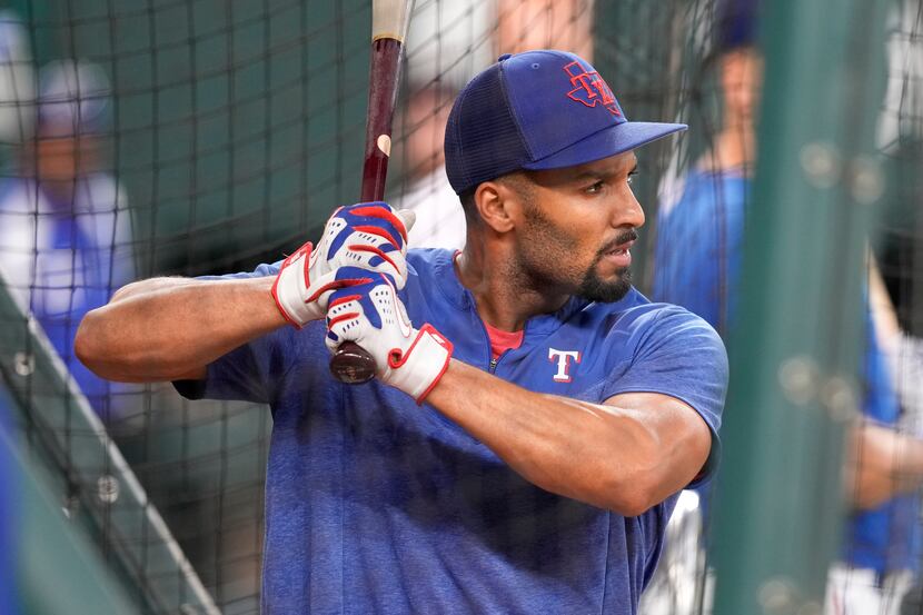 Texas Rangers' Marcus Semien waits for the throw during batting practice before a baseball...