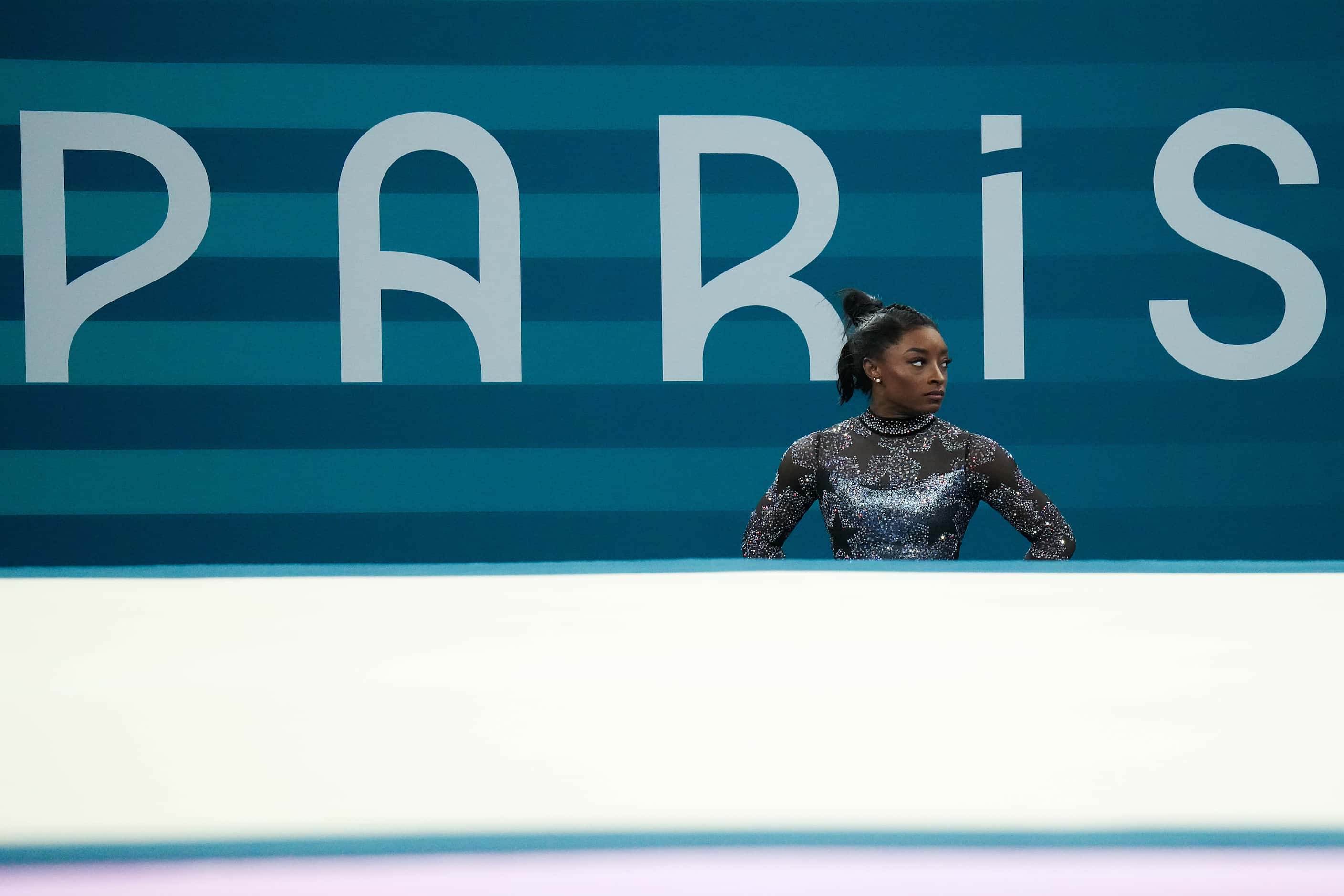 Simone Biles of the United States waits to compete on the floor during women’s gymnastics...