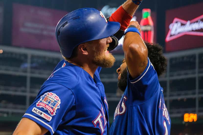 Texas Rangers designated hitter Hunter Pence celebrates with shortstop Elvis Andrus after...