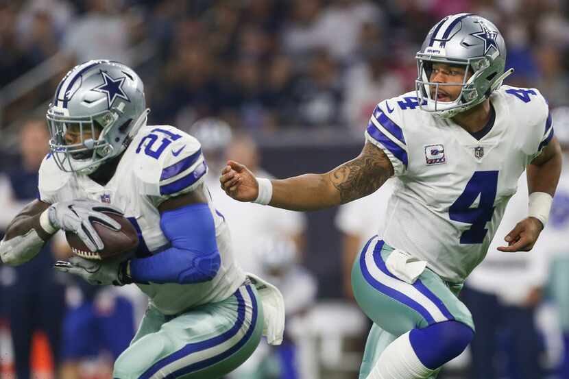 Dallas Cowboys quarterback Dak Prescott (4) hands off to running back Ezekiel Elliott (21)...