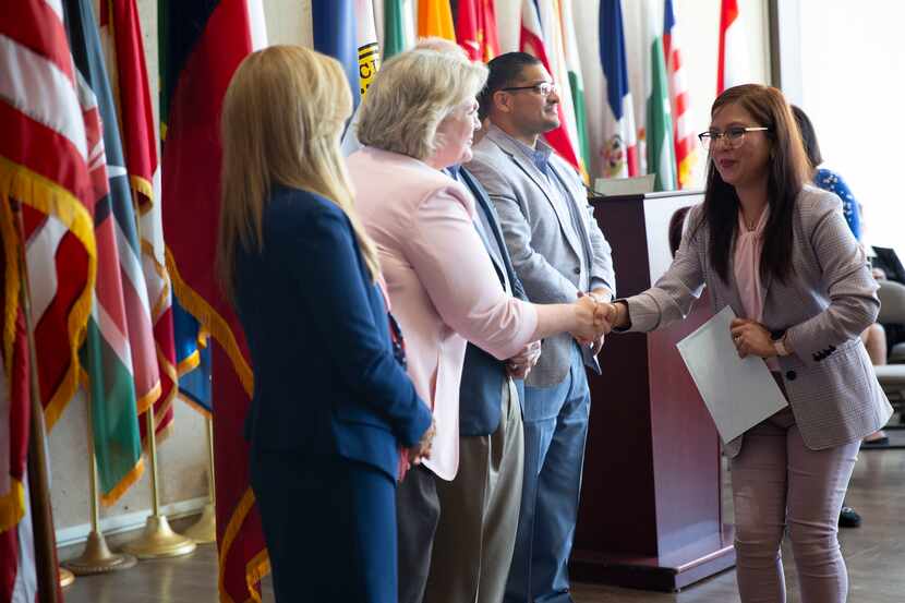 Evangeline Demetrio, who is from the Philippines, is congratulated after becoming a U.S....