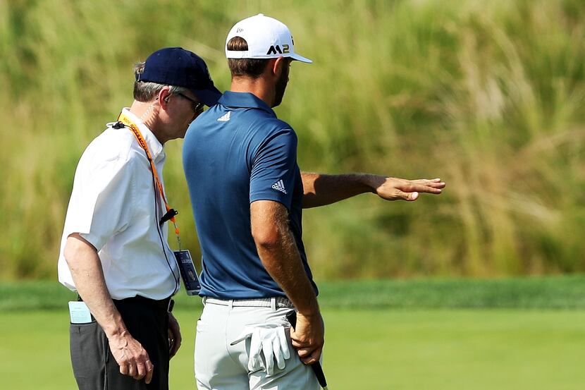 OAKMONT, PA - JUNE 19:  Dustin Johnson of the United States chats with a rules official on...