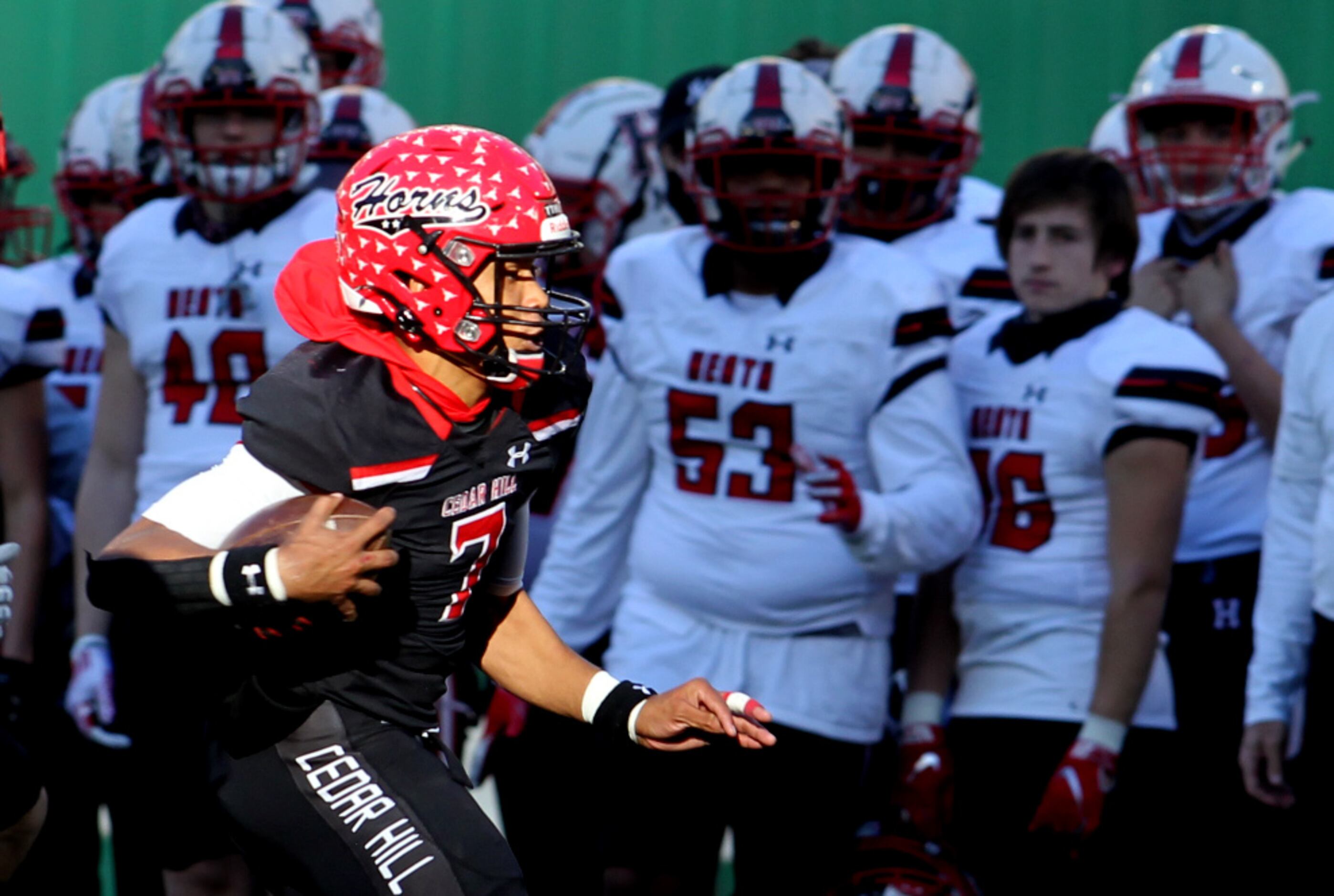 Cedar Hill quarterback Kaidon Salter (7) scampers down the sideline in front of the Rockwall...
