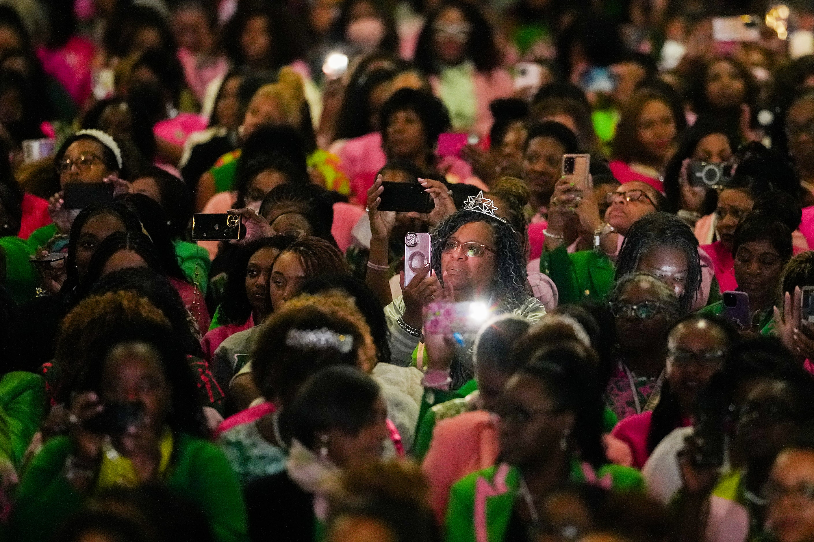 Delegates train their mobile phone cameras on Vice President Kamala Harris as she addresses...