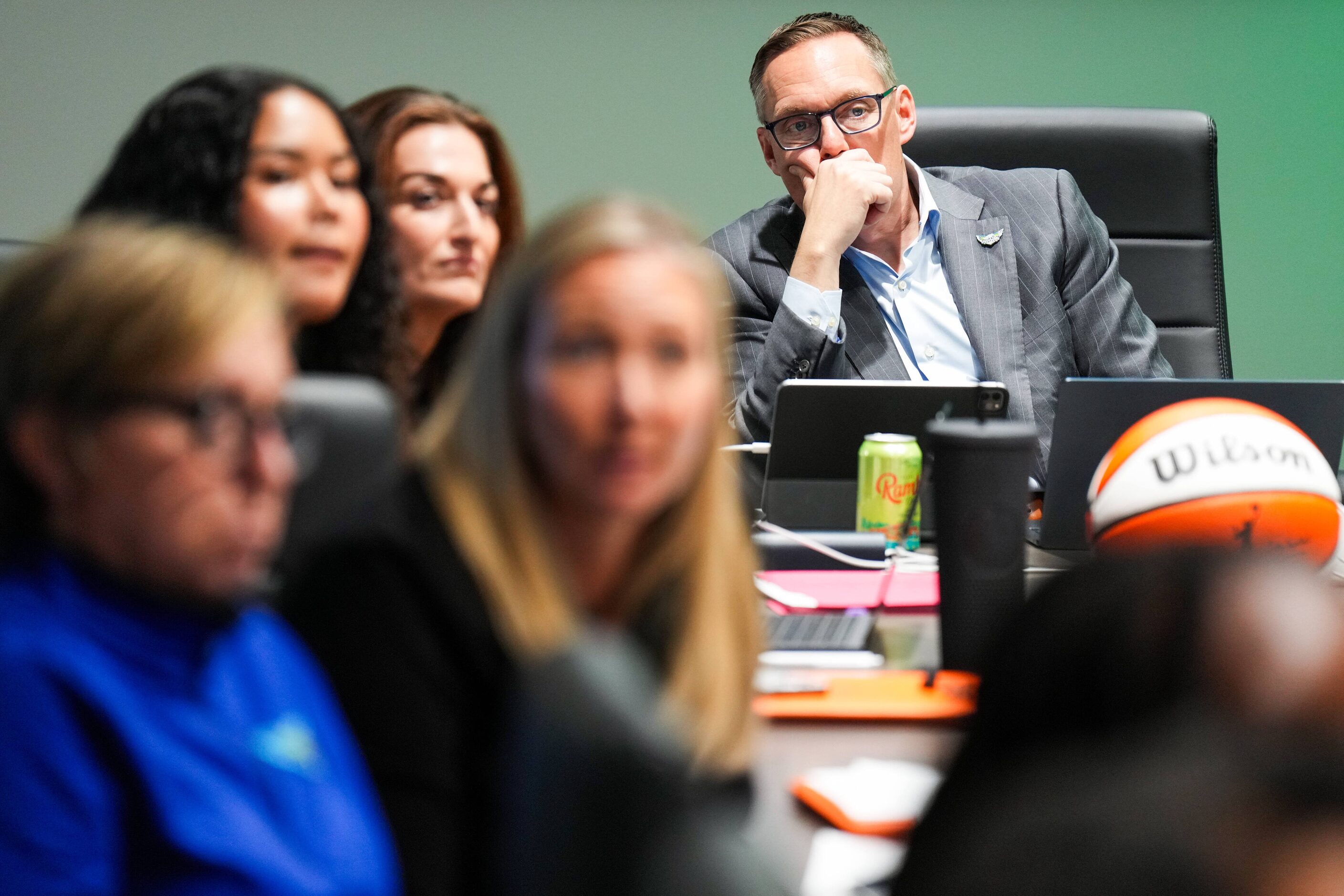 Dallas Wings President and CEO Greg Bibb watches coverage of the 2024 WNBA draft in the...