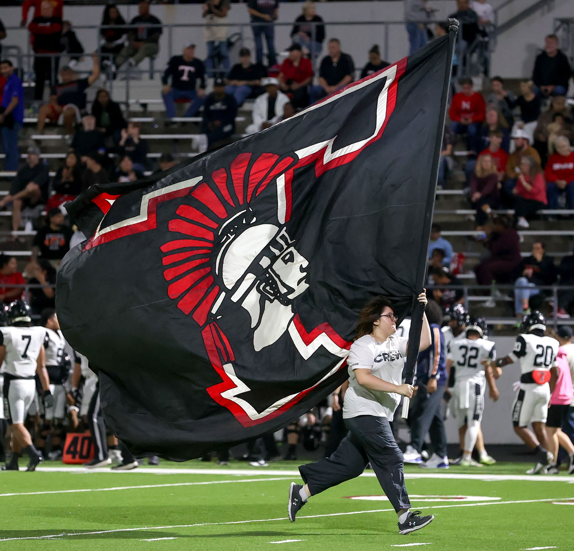 The Trinity Trojan flag goes across the field after a touchdown against Justin Northwest...