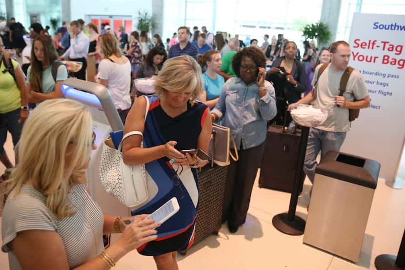 Passengers waited in line at the Southwest Airlines terminal at Dallas Love Field in July....