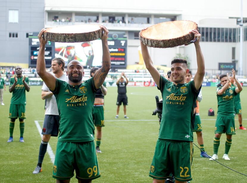 Portland Timbers players Samuel Armenteros (99) and Cristhian Paredes (22) celebrate their...