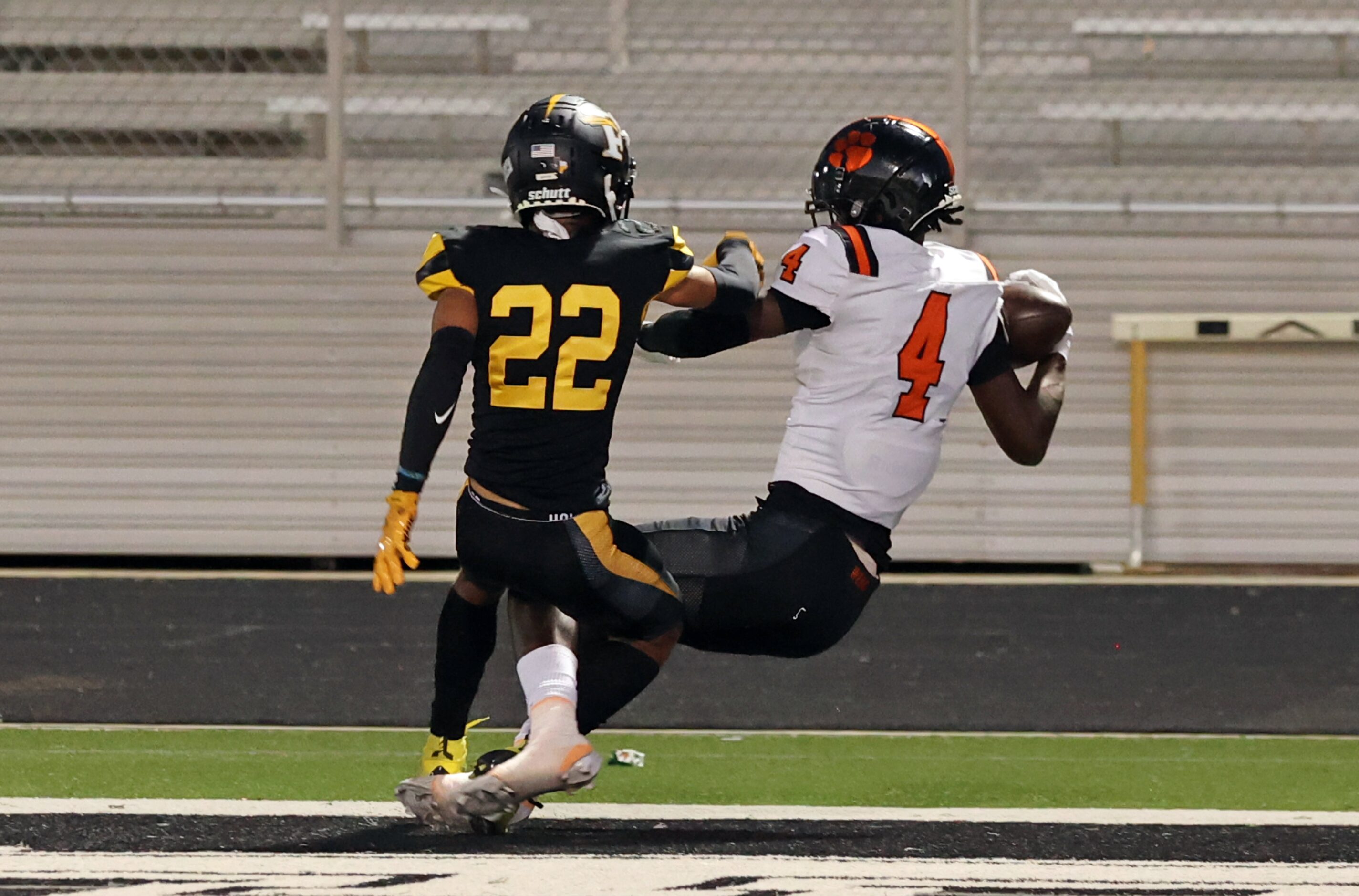 Lancaster high’s Emmanuel Choice (4) one-arms a pass for a touchdown, as Forney high’s...