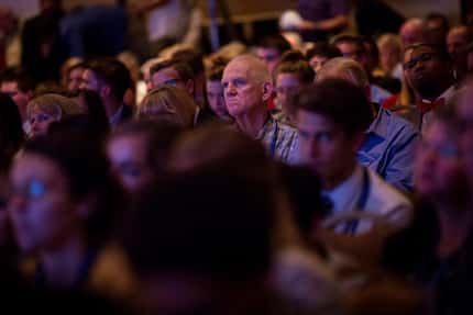 An attendee watches as Donald Trump addresses the Values Voter Summit, one of the largest...