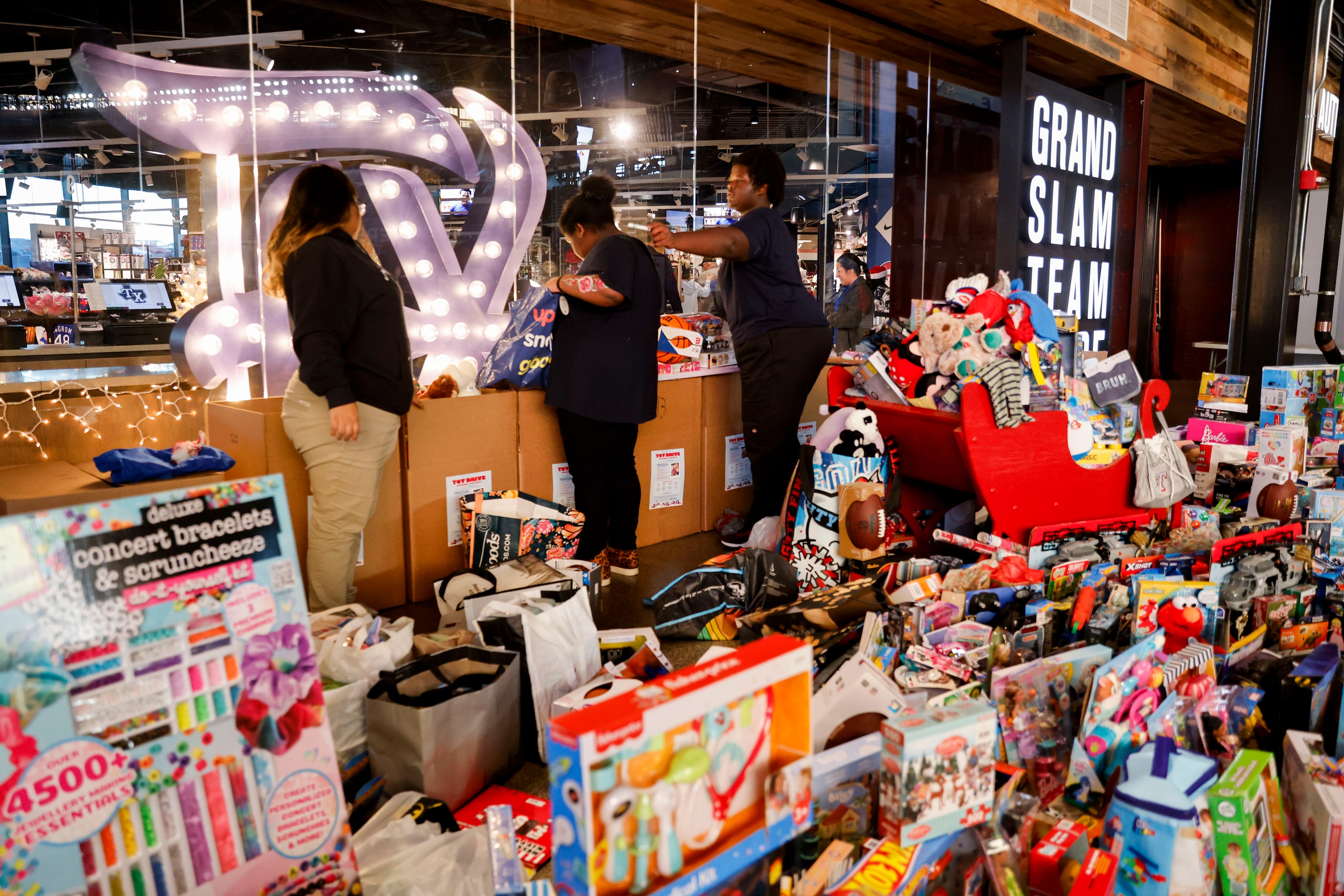 Gathered toys brought in by the crowd remain in front of the  Grand Slam Team Store during...