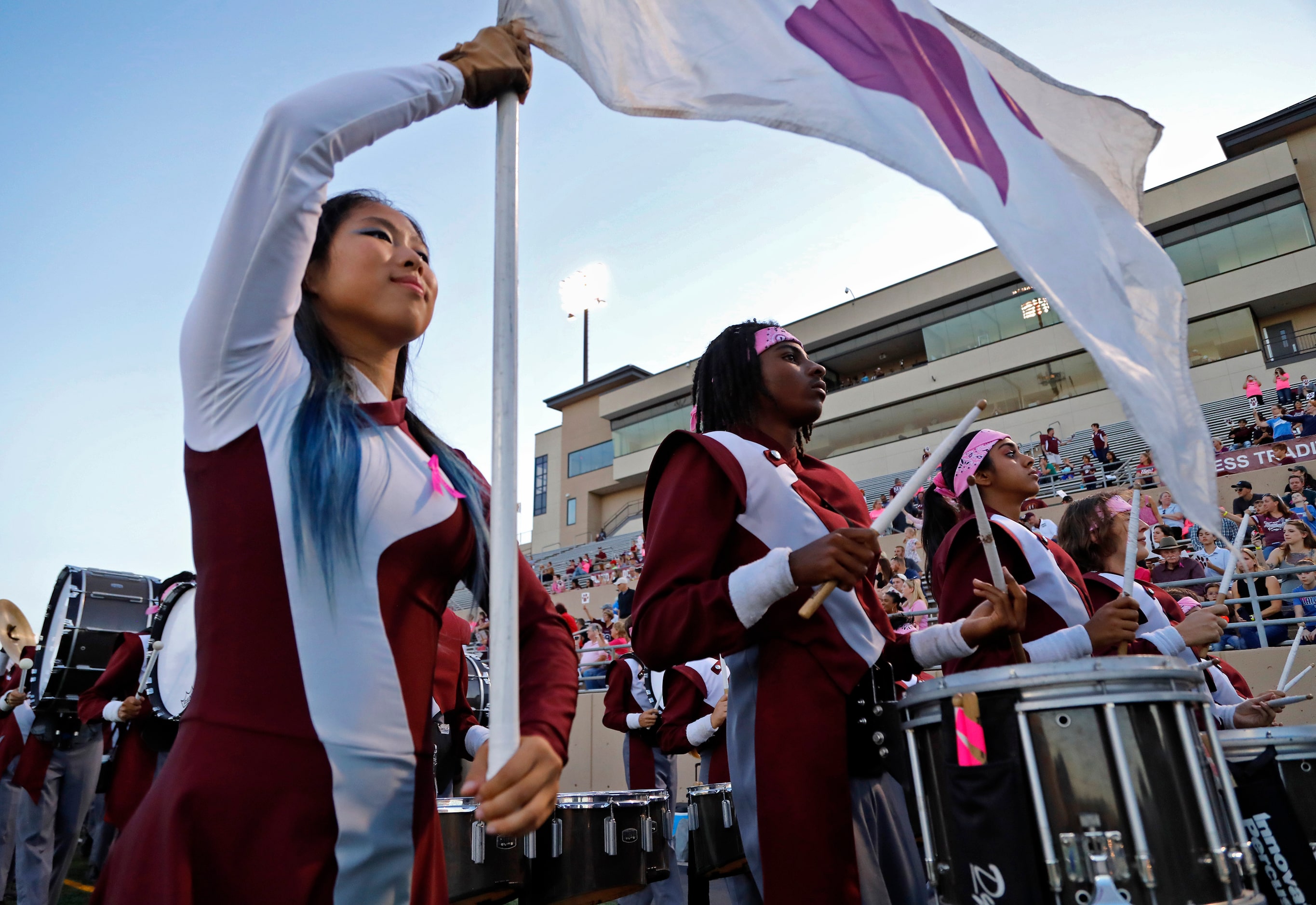 The Plano High School Marching Band takes the field before kickoff as Plano Senior High...