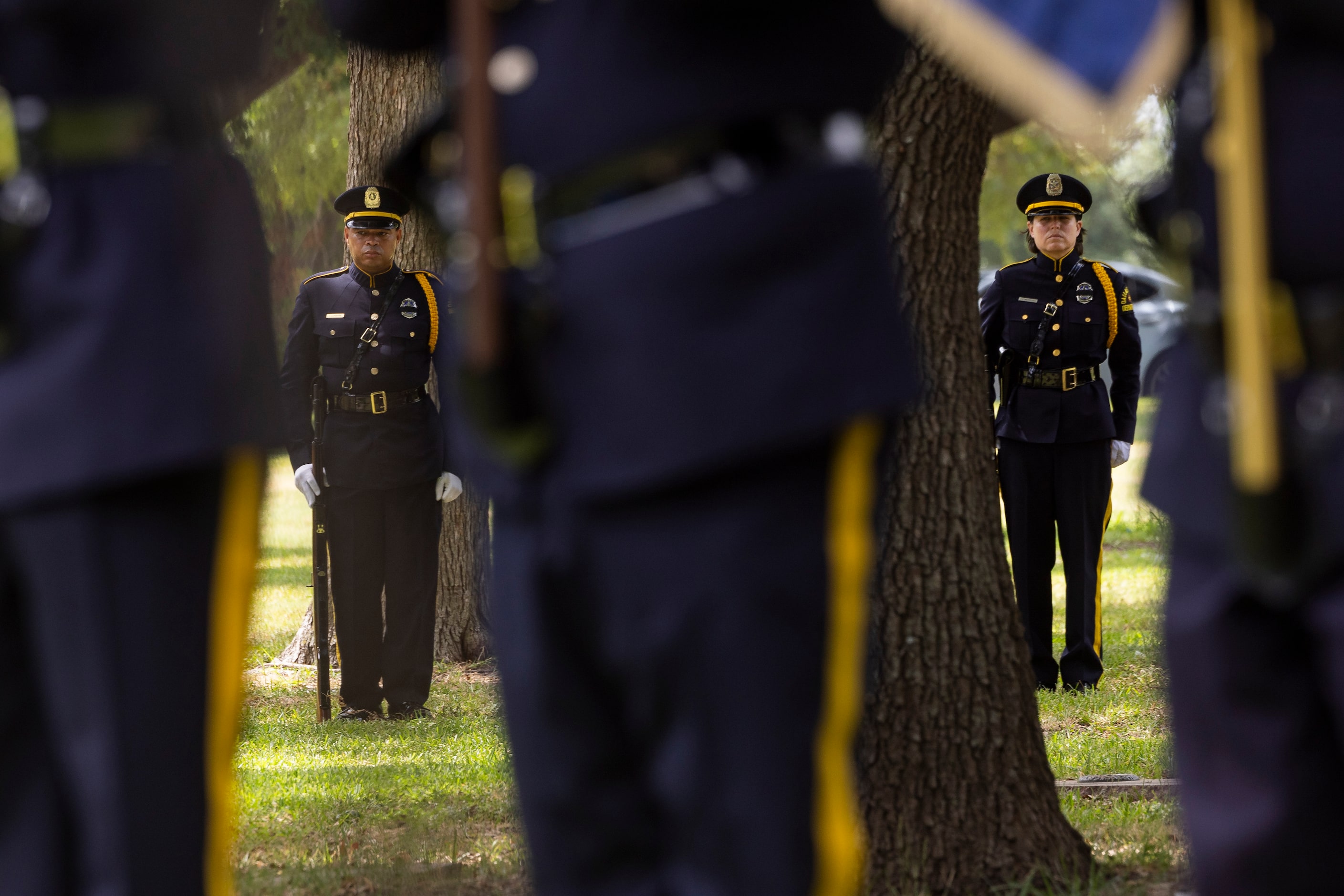 The Dallas Police Honor Guard stand at attention as they render full line-of-duty death...