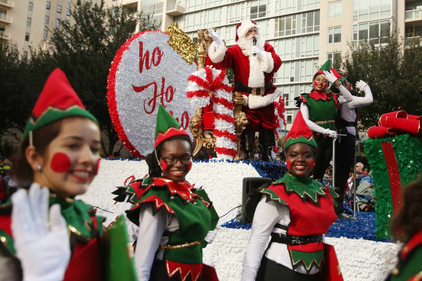 Santa Claus greets the crowd during the Dallas Holiday Parade through downtown Dallas .