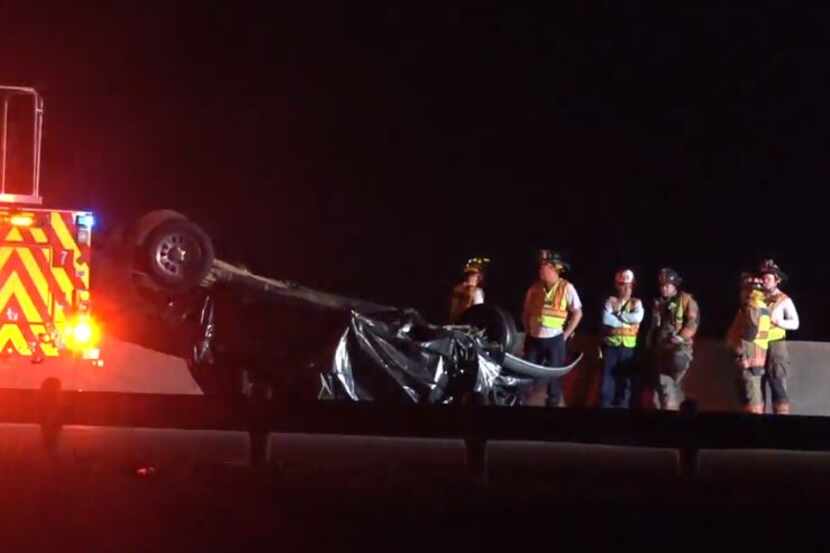 An overturned truck lies on Interstate 20 near Green Oaks Boulevard in Arlington on Tuesday...