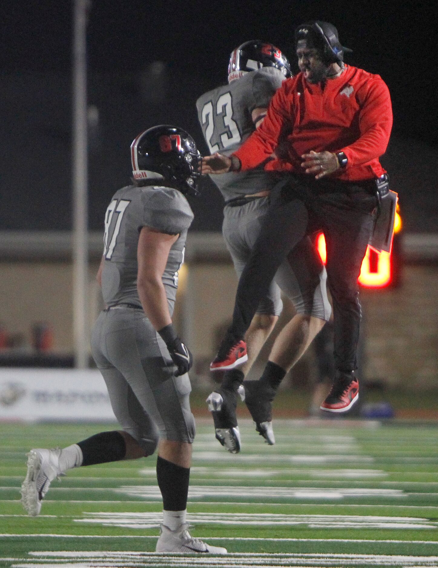 Lucas Lovejoy assistant coach Marcus Trice, right, skies as he celebrates with Leopard...