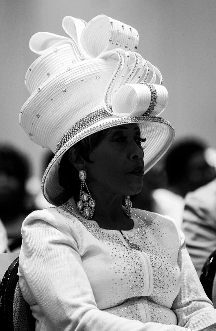  A woman wears a white hat during a communion and feet washing service at The National...