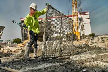 A worker on the site of luxury condos being built in Miami, March 3, 2016. Powered by a...