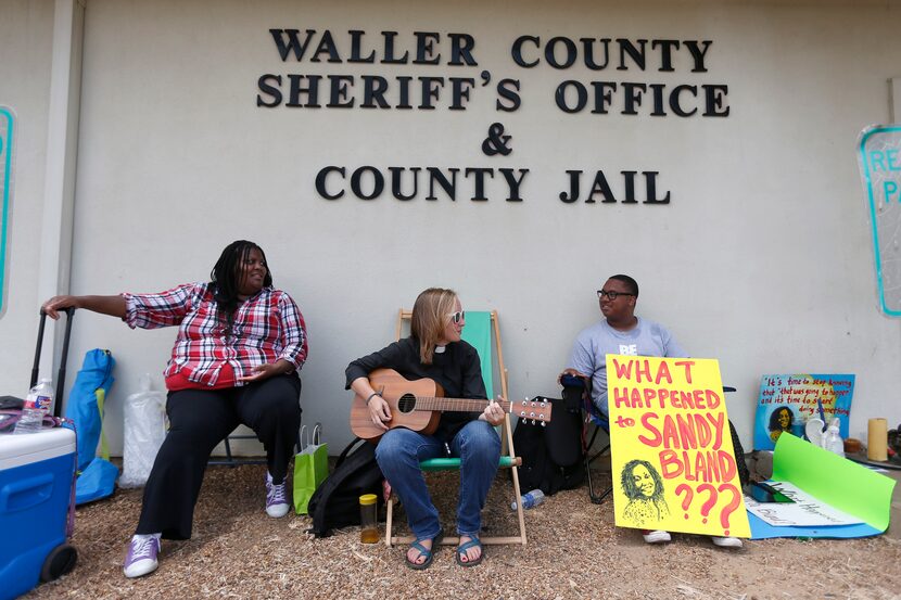 Carie Cauley, left, Rev. Hannah Bonner and Rhys Caraway protest, after the death of Sandra...