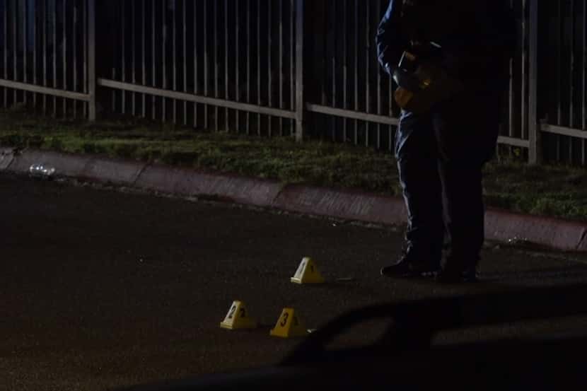 Evidence markers at the apartment complex where police were called to a shooting Saturday,...