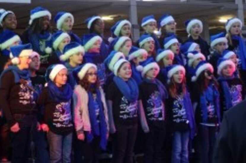  Members of the Hicks Elementary choir in Frisco kick off the pre-Santa performances at...