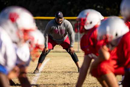 Spruce High School football coach Carl Richardson Jr. watches during football practice on...