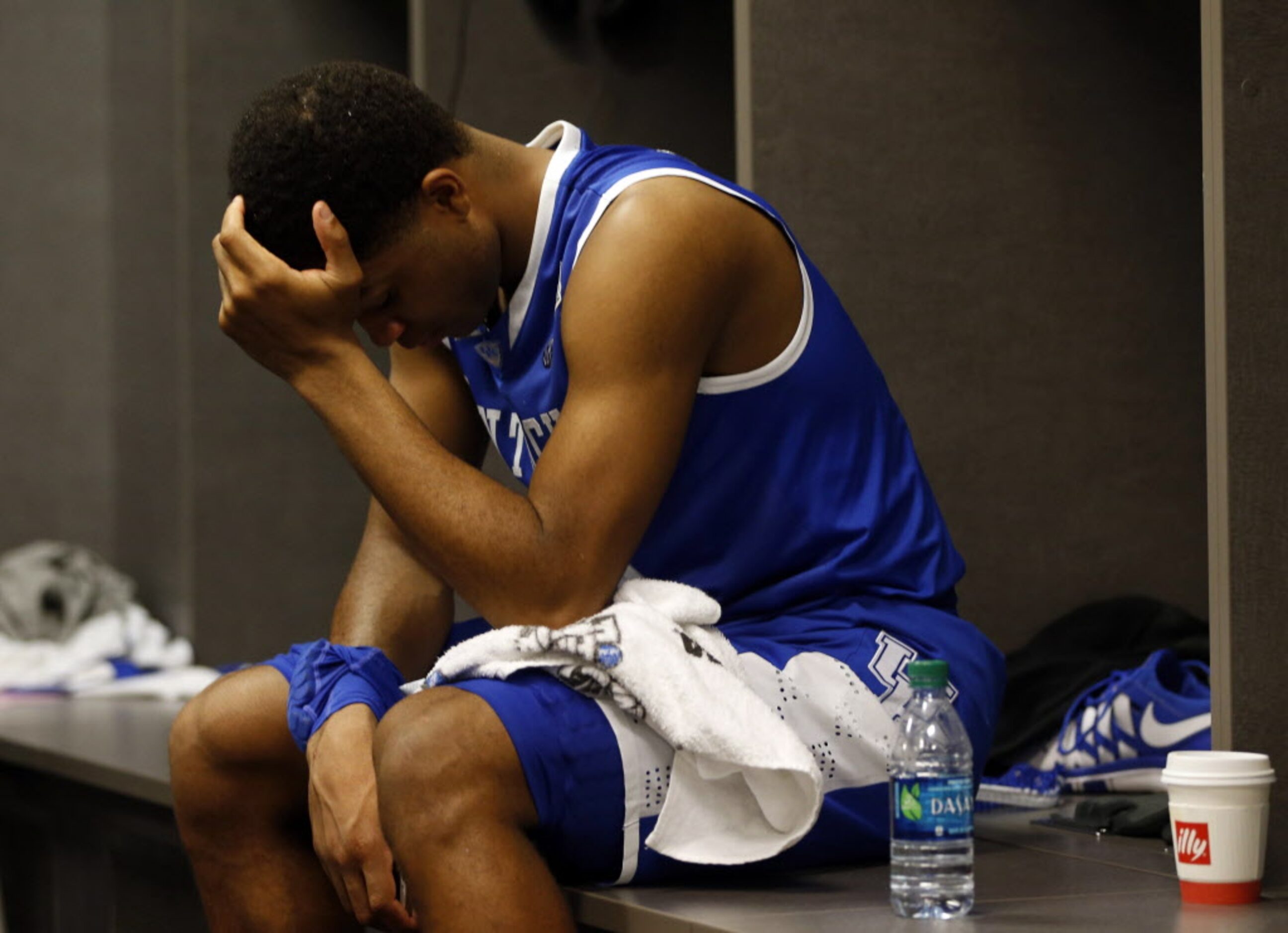 Kentucky Wildcats guard Andrew Harrison (5) sits dejected after losing to Connecticut...