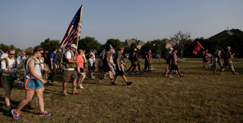 Participants began the 10 mile hump, a military term for a march while carrying a heavy...