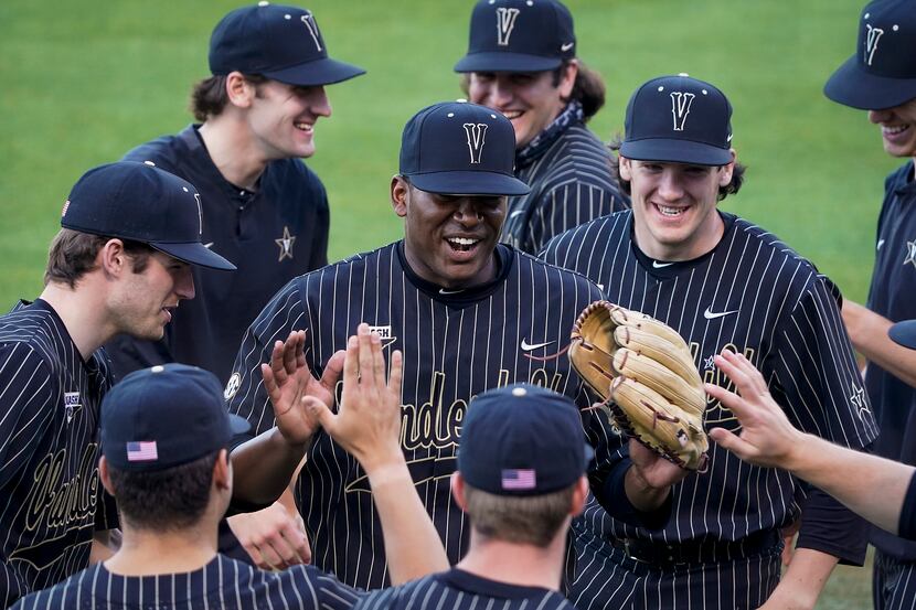 Vanderbilt pitcher Kumar Rocker celebrates with teammates after completing an inning an NCAA...
