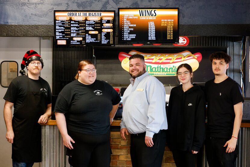 From left, Nearly Famous Burgers and Hotdogs assistant manager, Drew Bertram, employee...