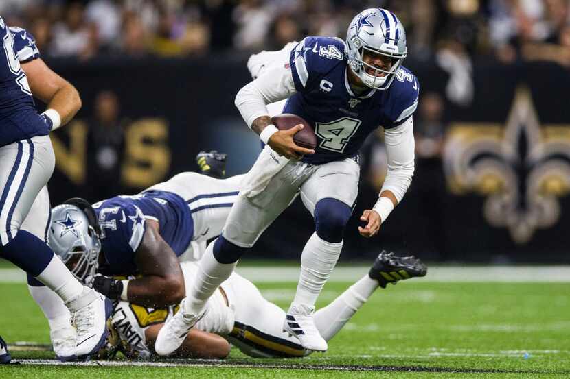 Dallas Cowboys quarterback Dak Prescott (4) runs the ball during the first quarter of an NFL...
