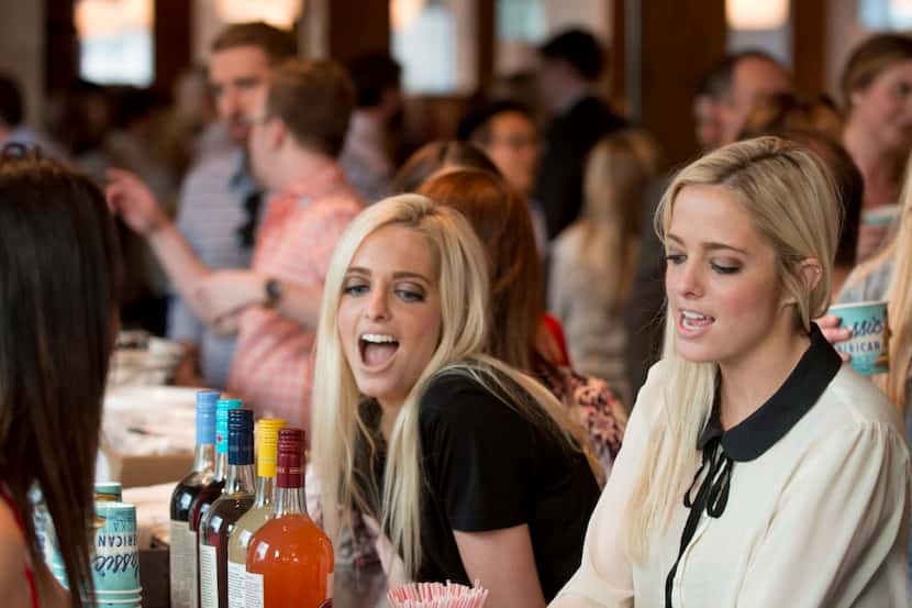 Twin sisters Avery (left) and Ellery Mileger chat at the bar during a party hosted by men's...