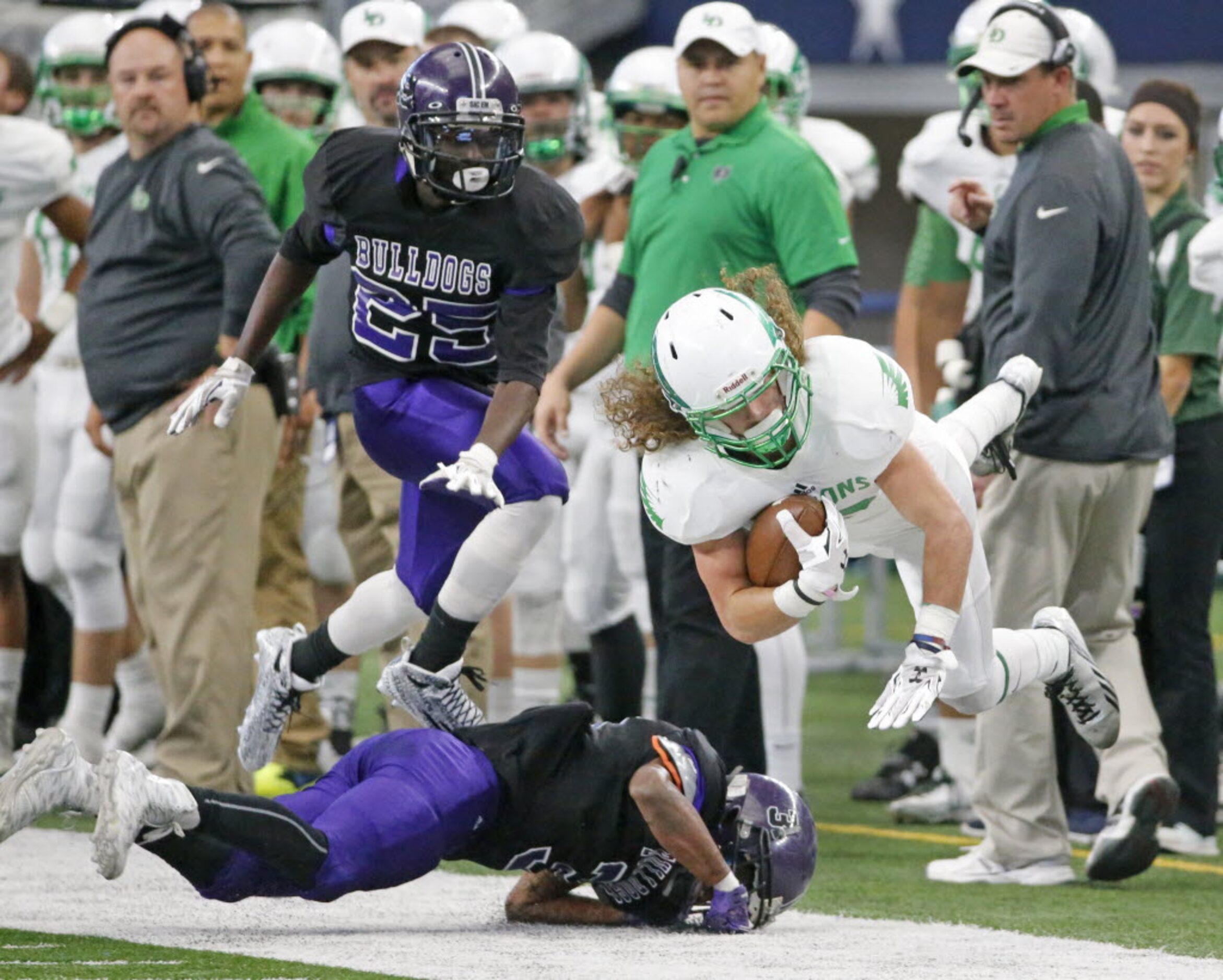 Lake Dallas receiver Keegan Brewer (12) is knocked out of bounds by Everman's Quentin Lewis...